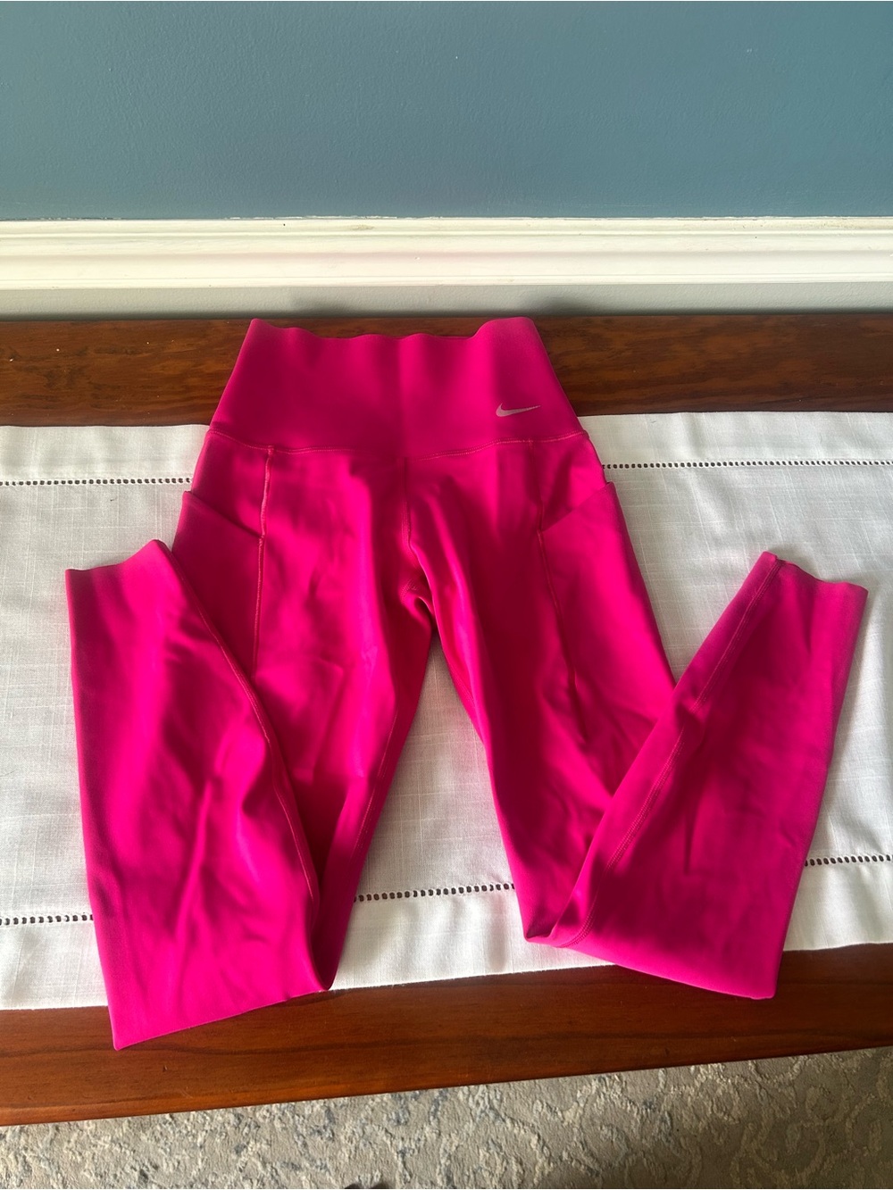 Nike Universa Dri-FIT hot pink activewear apparel with a black swoosh logo